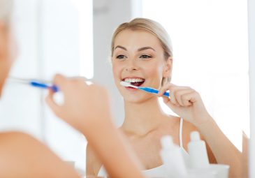 health care, dental hygiene, people and beauty concept - smiling
